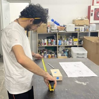 Participant using tape measure to layout blocks in manual experiment